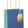Blue paper gift bag with handles and gold oval tag for The Wraperie, customizable gift wrapping services and eco-friendly packaging, perfect for special occasions and gift-giving.