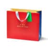 Red paper gift bag with white handles, green tag, and "A BIG BAG OF FUN" text.