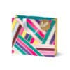 Bright colorful gift bag with geometric stripe patterns, white ribbon handle, and a gold circular tag with "HOORAY!" for special celebratory occasions.