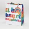 Tape theme gift bag from The Wraperie with colorful rainbow and happiness text design and rainbow tag for celebrations and special occasions.