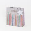 Colorful birthday cake gift bag with candle illustrations, "Best Wishes" message, and star-shaped tag, perfect for celebrations and party favors.