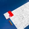 Coloring sheet featuring London landmarks and attractions, accompanied by red, yellow, and blue markers, on a vibrant blue background perfect for creative activities and children's entertainment.