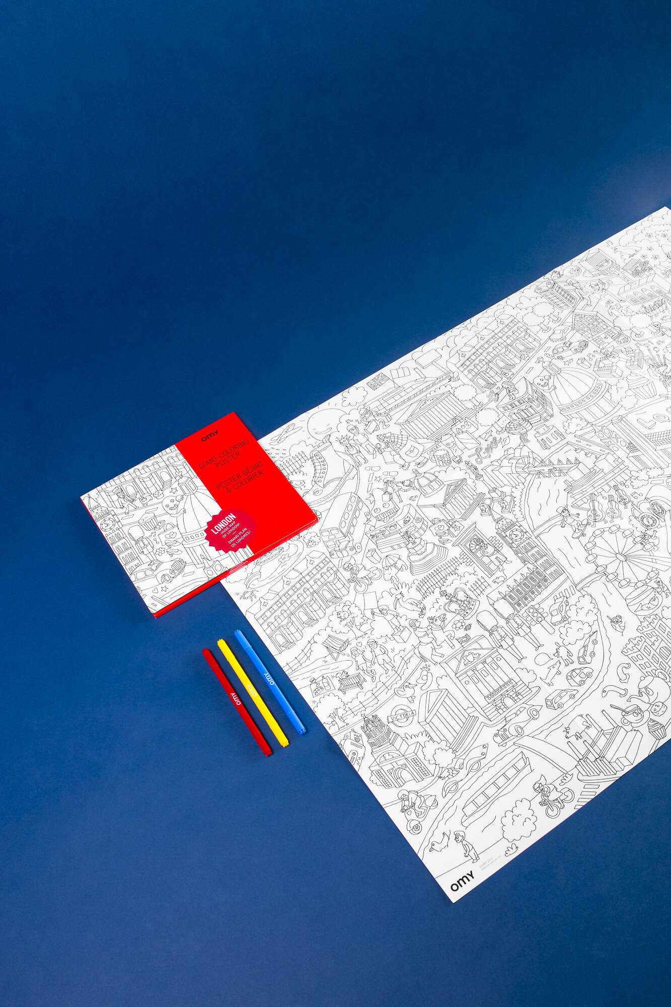 Coloring sheet featuring London landmarks and attractions, accompanied by red, yellow, and blue markers, on a vibrant blue background perfect for creative activities and children's entertainment.