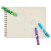 Colorful markers on a blank notebook with space-themed doodles, ideal for creative food wrap designs at The Wraperie.