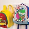 Bright kids' backpacks with colorful dinosaur and car designs, perfect for school and daycare, featuring durable materials and fun patterns.