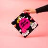 Bright colorful unicorn and rainbow themed packaging for The Wraperie, a food and dessert wrap shop, with pink background, vibrant design, eye-catching packaging, and playful illustrations for appealing presentation.