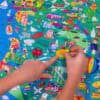 Colorful illustrated kids' world map puzzle showing landmarks, animals, and cityscapes, perfect for educational play and engaging young children.