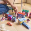 Colorful paper city toys with buildings, vehicles, and characters for kids' creative play and storytelling.