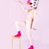 Colorful unicorn-themed food wrap shop character with a unicorn head mask, standing on a stool, showcasing creative wrap designs for The Wraperie.