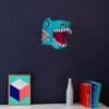 Colorful dinosaur paper lantern decor on a dark wall.