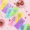 Colorful birthday cake toppers with sprinkles shaped as numbers 1-9 on pastel backgrounds, perfect for celebrations and dessert decor.