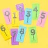 Colorful rainbow confetti cake toppers numbered 0-9 on vibrant background cards, perfect for birthday celebrations, cakes, cupcakes, and party decorations.