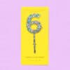 Colorful confetti cake topper in the shape of the number 6 on a yellow card against a pastel purple background, perfect for decorating birthday cakes with fun and vibrant detail.