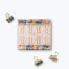Colorful floral-patterned binder clips set on a white background, stylish organization accessories for office or home.