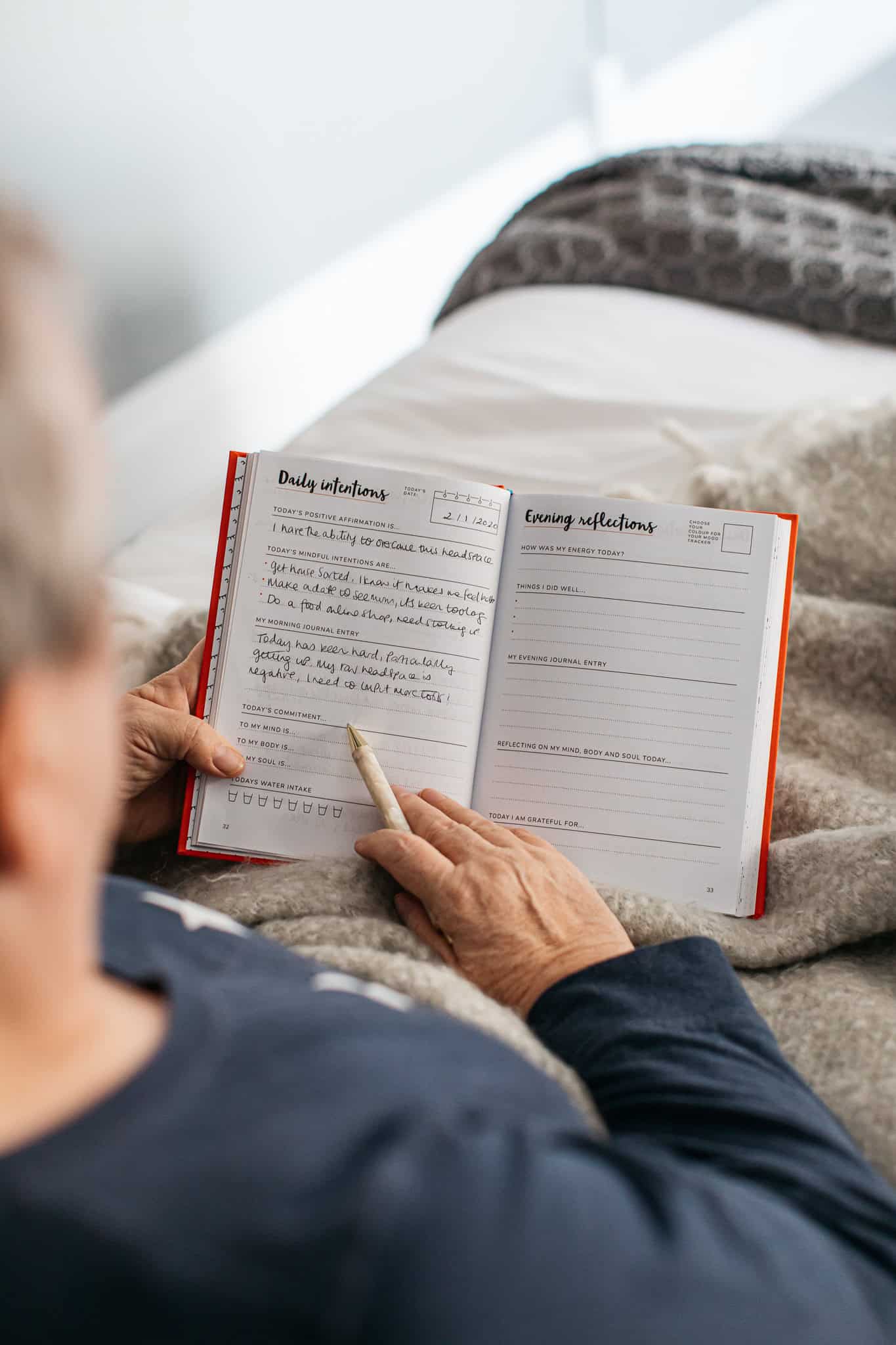 Daily journal planner for mindfulness and mental wellness at The Wraperie, highlighting organized space for goals, reflections, and intentions to promote healthier living.