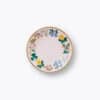 Colorful floral ceramic plate with gold rim, perfect for serving desserts or snacks at The Wraperie. Elegant tableware enhances your dining experience with vibrant flower patterns.