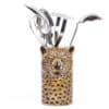 Stainless steel kitchen utensils in a decorative leopard print holder, perfect for cooking and baking. Unique leopard-themed utensil holder adds style to any kitchen decor.