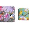 Colorful bird and flower printed tins, attractive storage containers with nature-inspired designs from The Wraperie. Perfect for organizing personal items with artistic, vibrant illustrations of birds and blossoms.