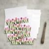 Colorful tulip-themed stationery set with matching envelopes, perfect for spring greeting cards and personalized notes, showcasing floral design and high-quality printing from The Wraperie.