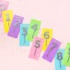 Colorful confetti cake toppers shaped like numbers 0-9 on pastel background, perfect for birthday celebrations, handmade, and vibrant party decor.