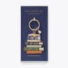 Colorful book stack enamel keychain inspired by classic novels, perfect for book lovers and collectors. Features detailed lettering and vibrant design, ideal for gifting or accessorizing.