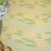 Colorful floral tablecloth from The Wraperie, featuring yellow and green patterns, perfect for creating vibrant dining settings.