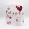 Elegant baby shower gift bag with "Baby girl" message, pink and gray polka dot design, perfect for celebrating a newborn girl. Ideal for gifting at baby showers or welcoming a baby girl.