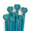 Blue pens with heart-shaped toppers featuring "Be Kind" message, promoting kindness and positivity. Perfect for school supplies, office use, or gifting to spread compassion and encouragement.