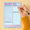 Bright blue and pink busy schedule planner with checklists and goal sections, designed for organizing daily tasks, shopping lists, and personal goals effectively. Perfect for productivity enthusiasts.