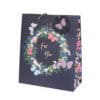 Vibrant gift bag with floral wreath, butterflies, and "For You" message, perfect for special occasions and gifting.