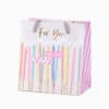 Colorful birthday gift bag with candles, "For You" message, and playful design, perfect for celebrating special occasions and adding joy to gift-giving moments.