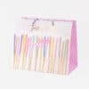 Bright birthday cake candles on a festive gift bag, perfect for celebrations and special occasions, featuring colorful, stylish designs from The Wraperie.