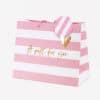 Pink and white gift bag with "A gift for you" lettering, gold heart accent, and pink striped round tag, perfect for special occasions and celebrations.