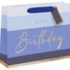 Colorful birthday gift bag with "Happy Birthday" message in elegant gold script on blue and white striped background. Perfect for celebrating special occasions with stylish wrapping.