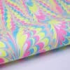 Pink, blue, and yellow marbled paper pattern, perfect for creative wrapping or DIY crafts.