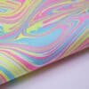 Vibrant holographic wrap with swirling pastel colors including pink, blue, yellow, and green, perfect for custom wrapping, crafts, and creative projects.