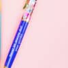 Colorful gel pen with holographic accents and inspirational quote, perfect for journaling or note taking.