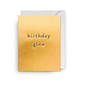 Glossy gold birthday card with embossed "birthday glow" message, perfect for celebrations and special occasions.