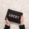 Lucky-themed rhinestone clutch bag for women, stylish accessory for parties and events. Elegant black purse with sparkling 