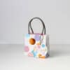 Colorful gift bag with Handle for Celebrations and Special Occasions at The Wraperie, perfect for packaging treats, gifts, or party favors with vibrant polka dot design.