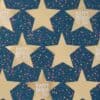 Colorful birthday wrapping paper featuring gold stars with "Happy Birthday to You" messages and multicolored confetti design, perfect for festive celebrations.