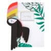 Vibrant toucan-themed envelope and paper airplane with tropical leaf accents, perfect for personalized greeting cards, invitations, or eco-friendly mailing solutions. Bright, colorful design by The Wraperie.