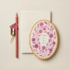 Pink floral thank you card on white background with pen, paper clip, and pencil.