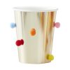 Colorful paper cup with decorative pom-poms, perfect for parties and celebrations.