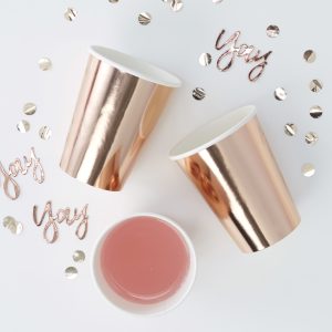 Shiny rose gold and white disposable cups with gold foil accents, celebrating special moments with personalized quality, ideal for custom event drinkware at The Wraperie.
