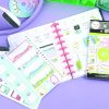 Cute pastel planner pages and stickers for organization and decorating, perfect for school or work scheduling, displayed with stationery on a purple background.
