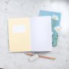 Blank stationery notebook with colorful floral and checkered covers, perfect for journaling and creative writing.