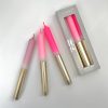 Bright pink and gradient dip-dye candles with gold holders from The Wraperie, perfect for home decor or special occasions, showcasing trendy candle designs and vibrant colors.