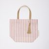 Pink and gold tote bag with striped pattern, gold handles, and decorative tassel, ideal for gift wrapping, shopping, or special occasions, from The Wraperie collection.