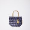 Elegant navy blue tote bag with gold geometric patterns and a tassel, perfect for stylish shopping and casual outings.